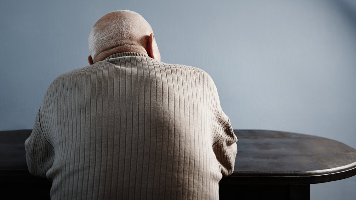 the back side view of an elderly man.