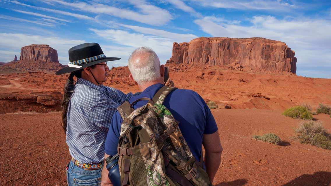 a Native American explains to a person the spiritual aspect of the land.