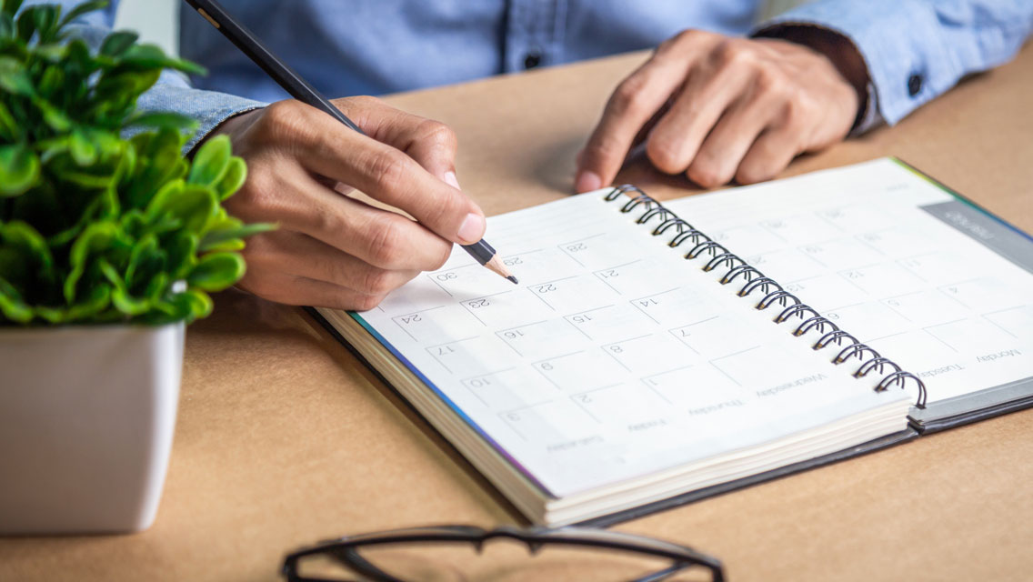 a person writes in their paper calendar