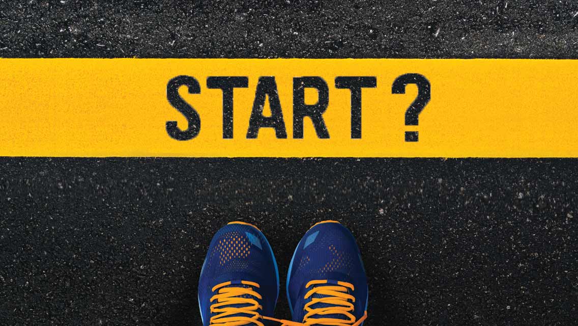 feet in running shoes at a starting line.