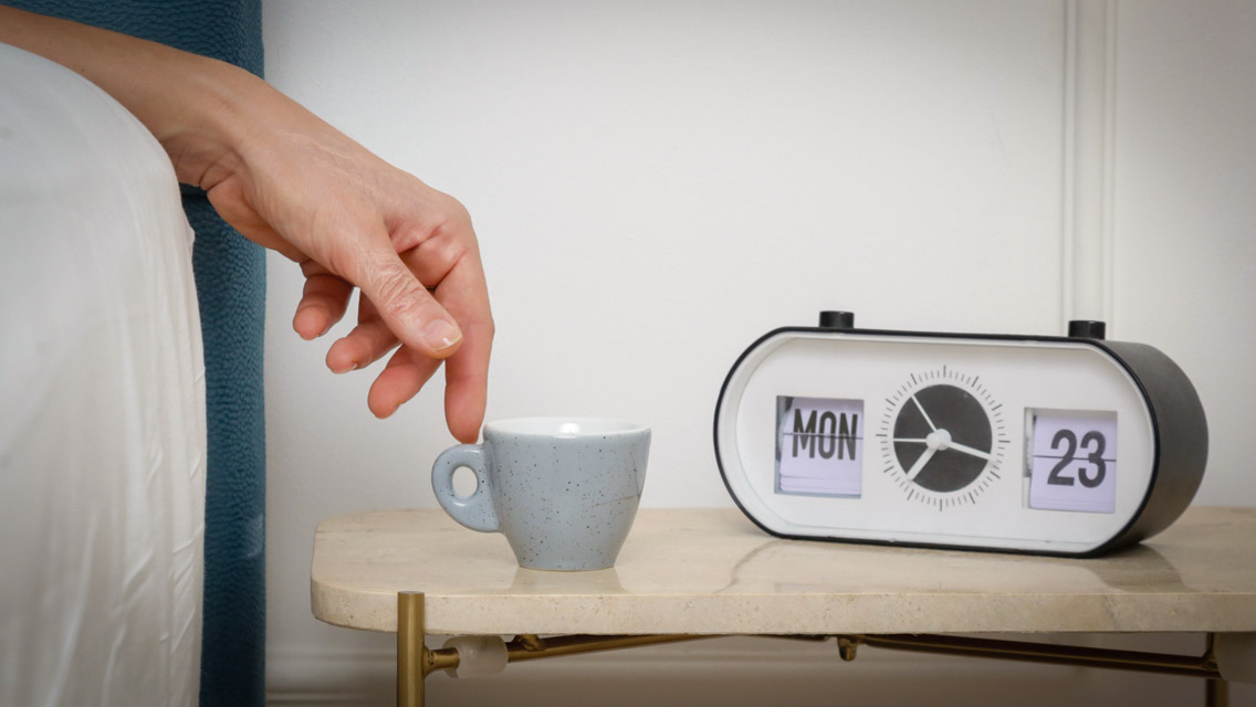 a nightstand with a clock set to Monday