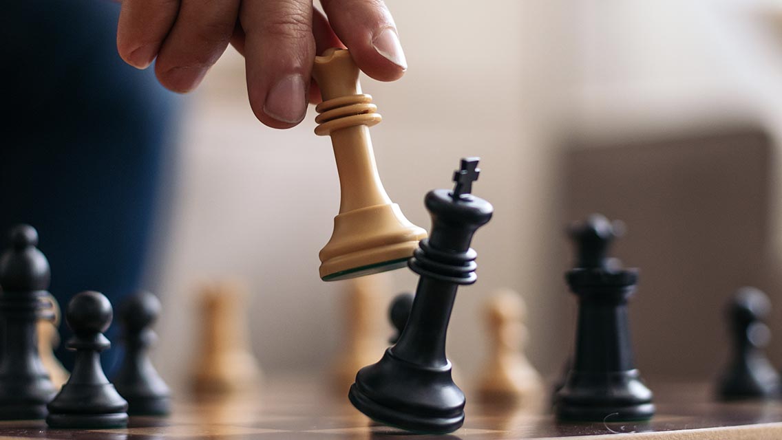 a game of chess with the king getting knocked down by another king