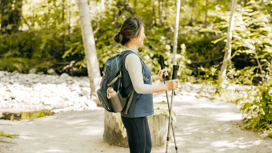 a woman uses nordic walking poles