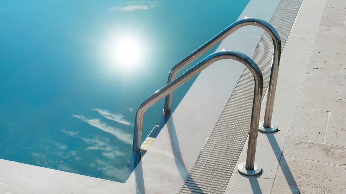 image of a pool with the sun and clouds reflected