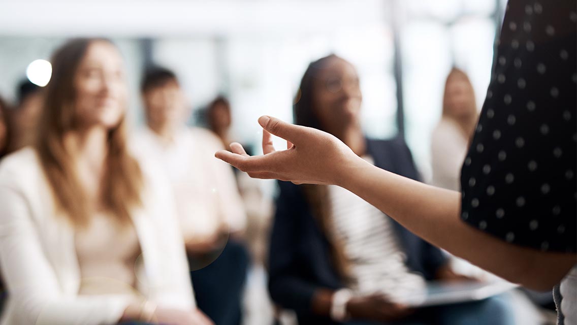 a person raises their arm while presenting.