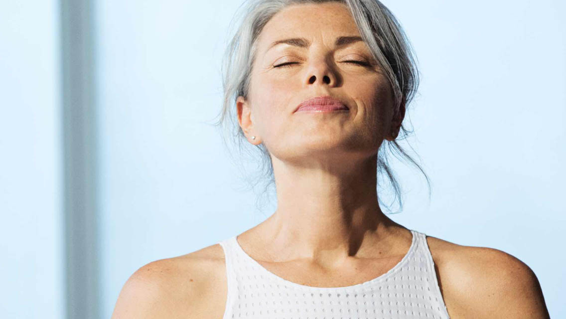 Woman with eyes closed looking peaceful.