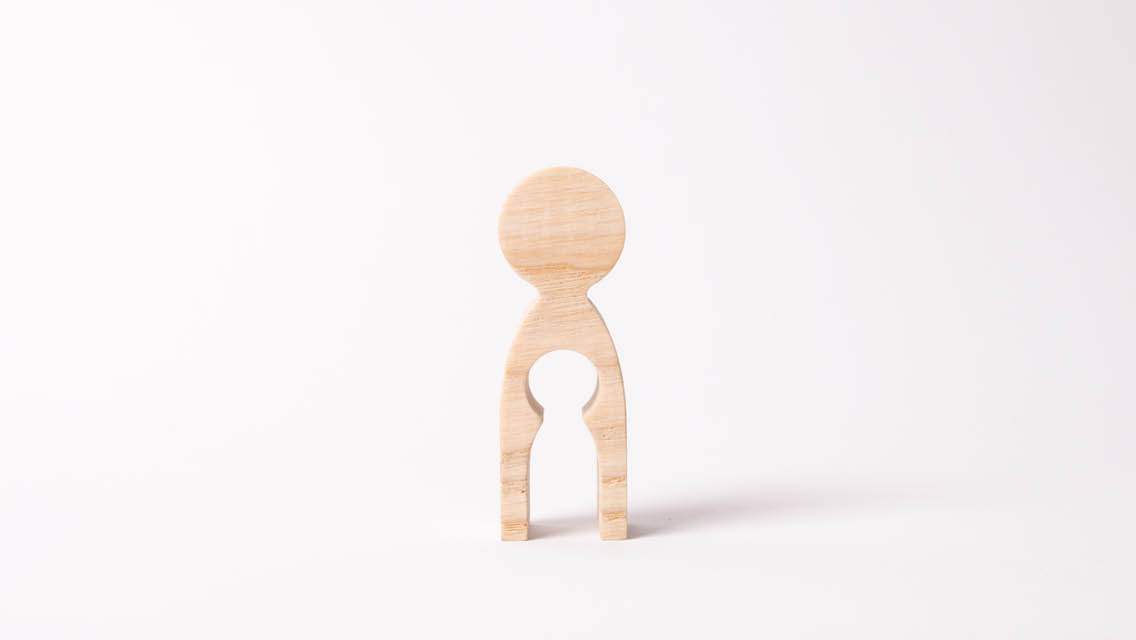 wood carving of a person with a child like hole