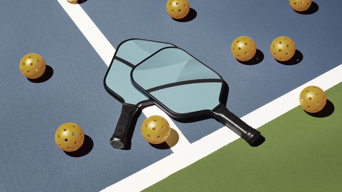 pickleball paddle and balls on the court