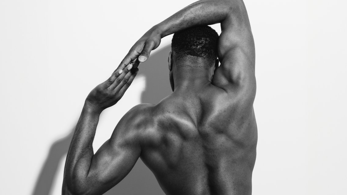 Person's back with arms raised over their head