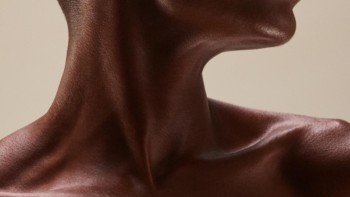 A close up of the skin on a woman's neck and collarbone area.