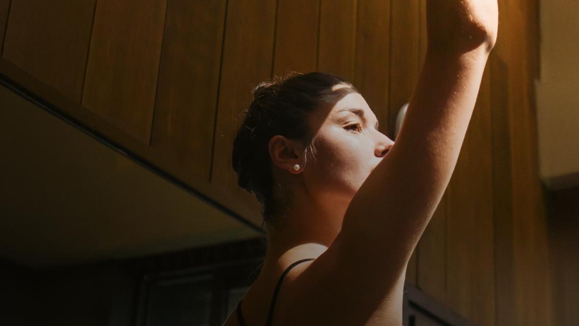 woman with hands above head