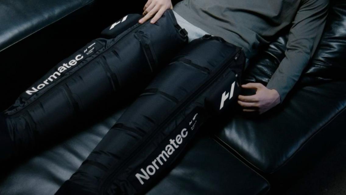 person using normatec boots