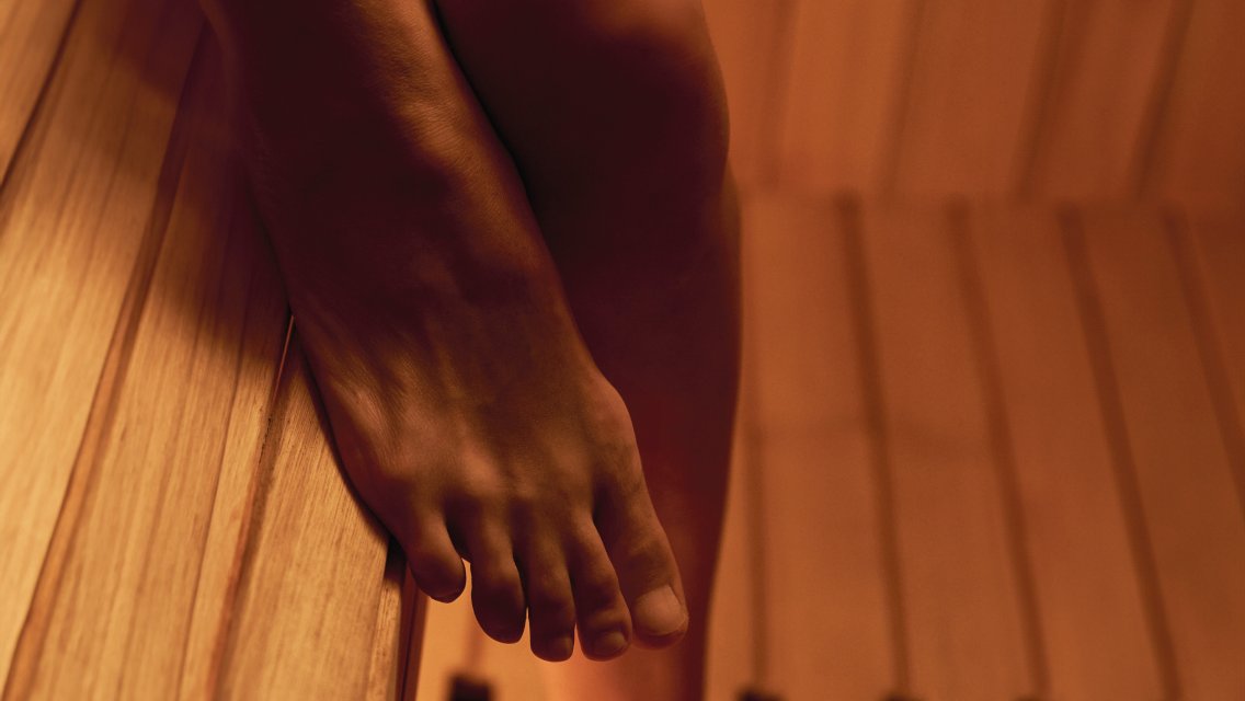 Close-up of a person's foot in a sauna
