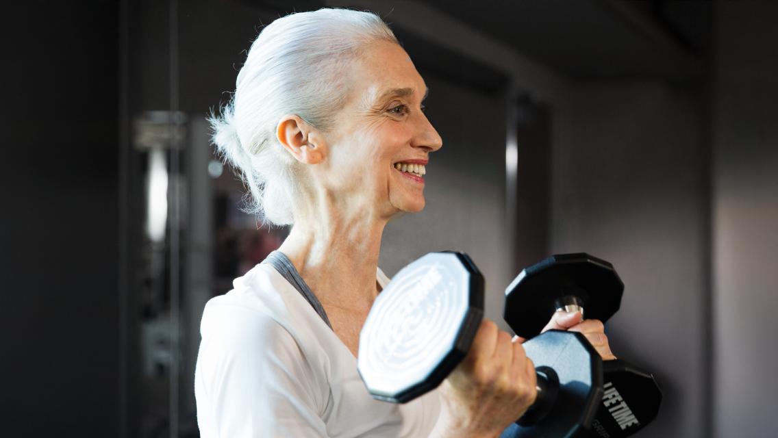 woman holding dumbbells