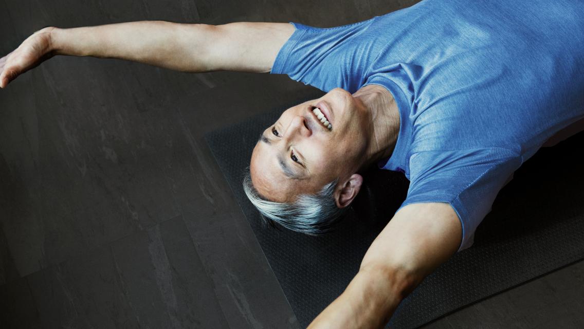 man with arms above his head