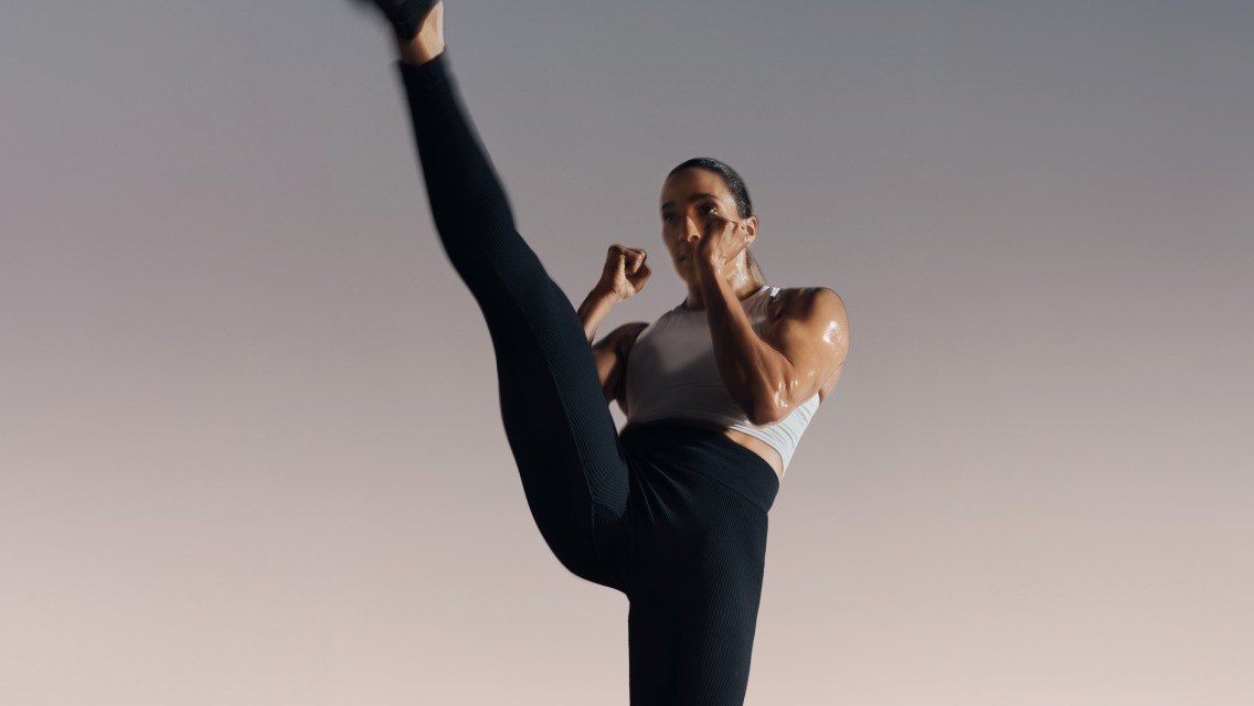 woman kicking her leg high in the air