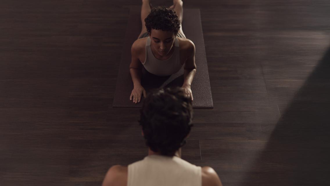 person on yoga mat doing stretch