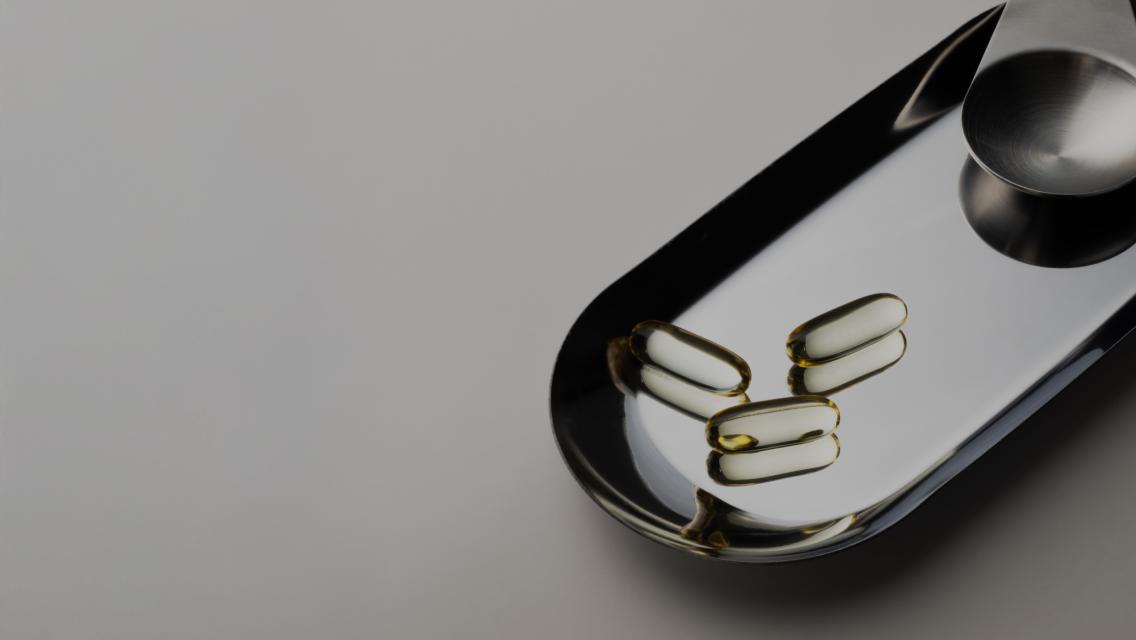 fish oil capsules on silver tray