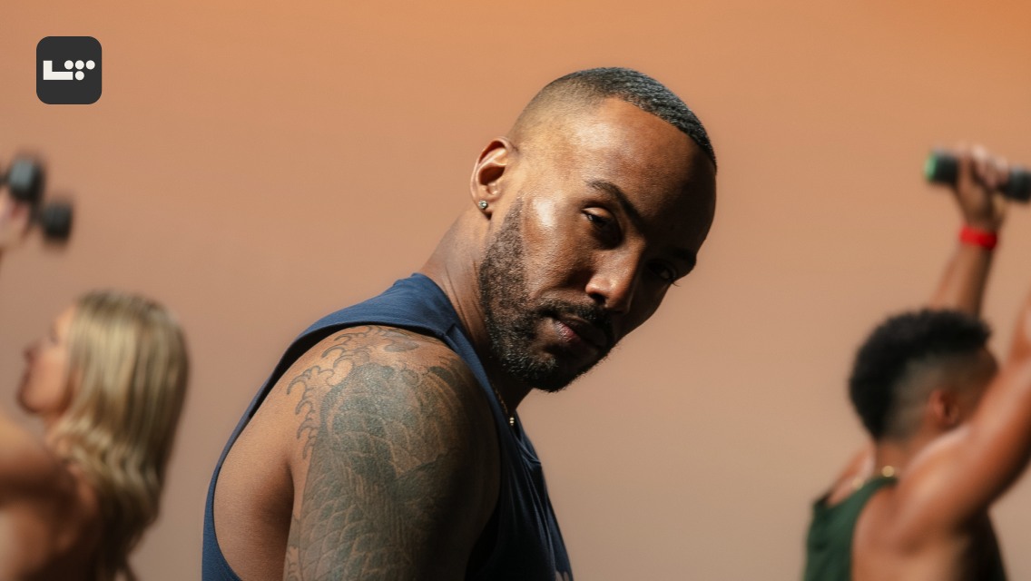 Performer Joseph David looking at the camera while leading a fitness class.