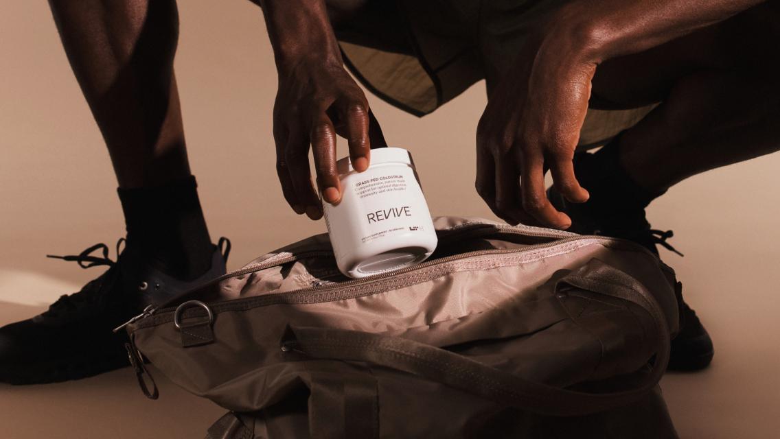 person putting supplement tub in workout bag