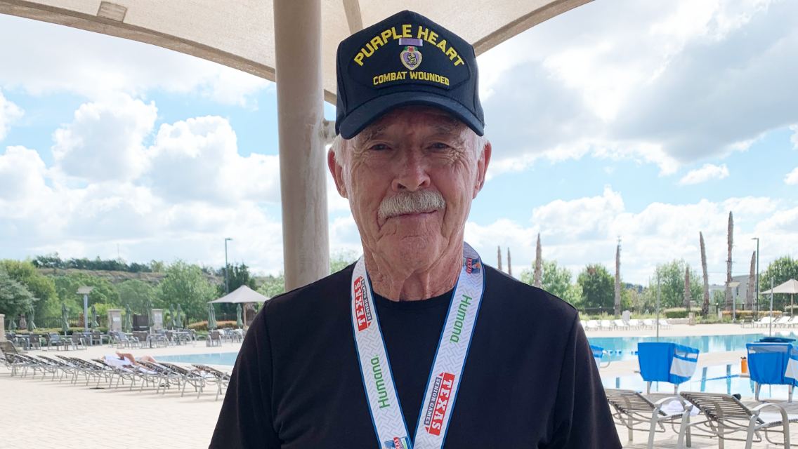 Tommy Blake standing in front of a pool at Life Time.
