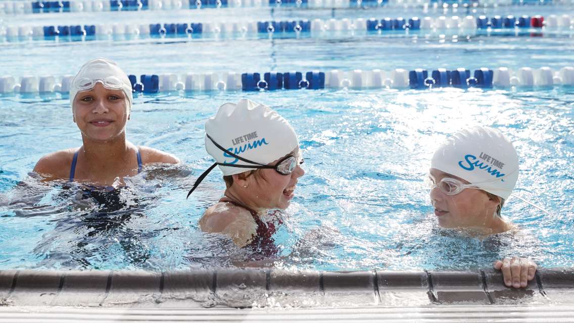 Three kids swimming in the pool