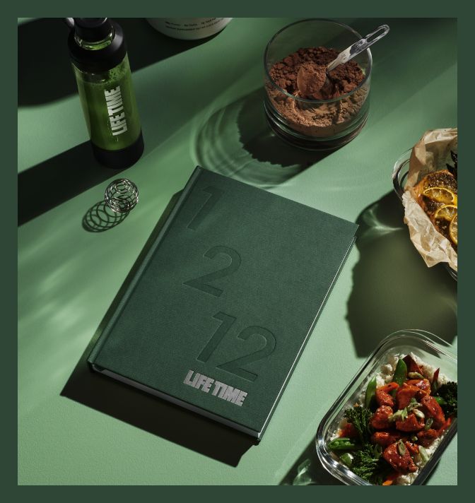 The contents of the 1/2/12 nutrition kit, including the cookbook, shaker bottle, and glass meal prep containers.