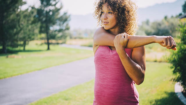 Pregnant woman stretching arm