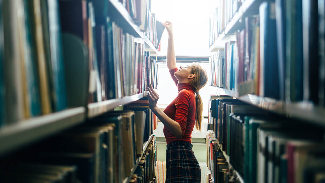 a woman explores books