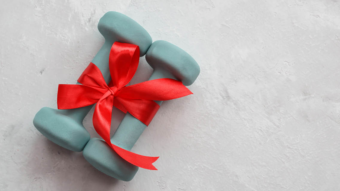 hand weights with a red ribbon tied around them