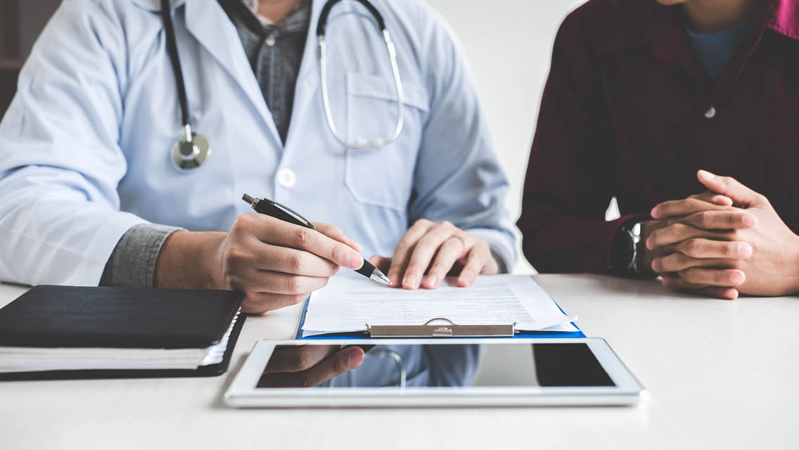 a doctor reviews test results with a patient