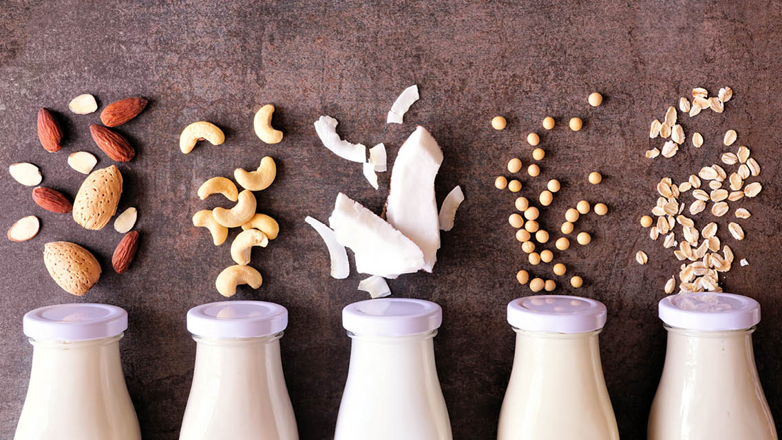 milk bottles with various main ingredients arranged as though they are spilling out