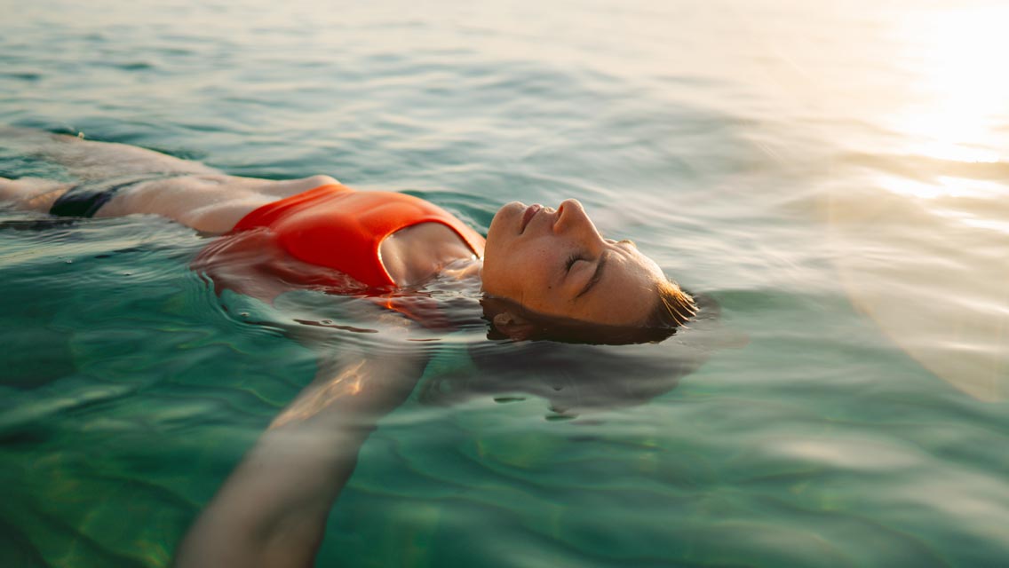 a woman floats effortlessly in the water
