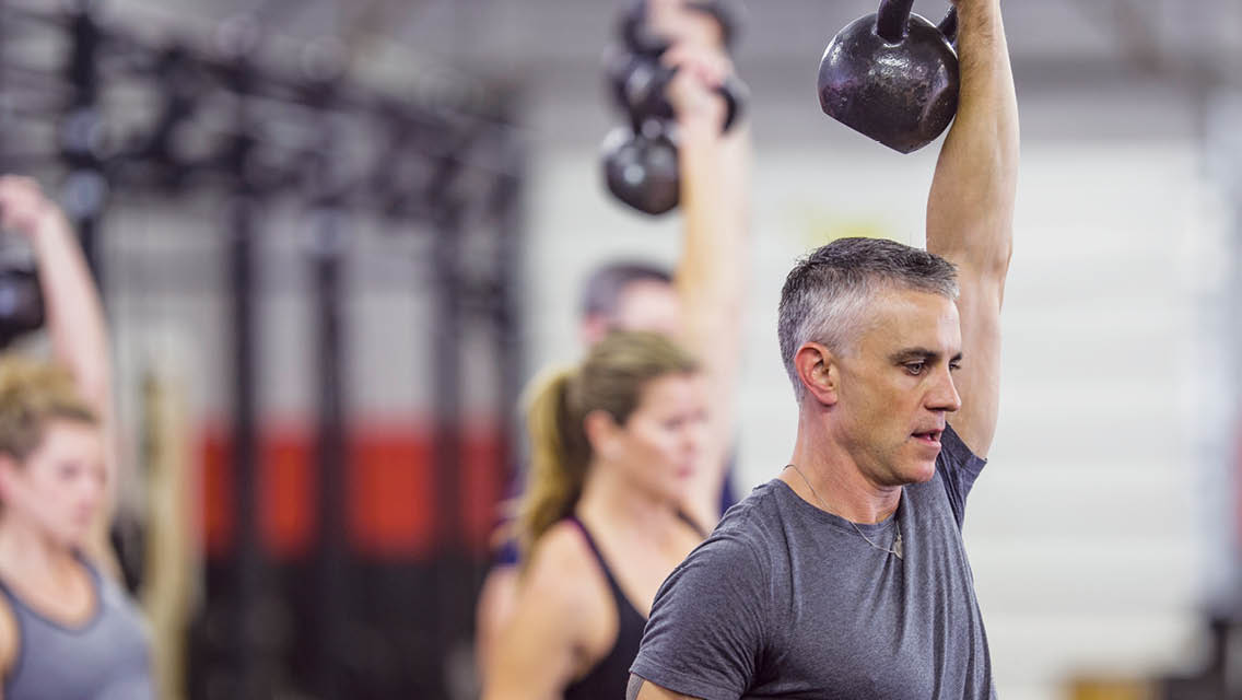 people lifting kettlebells.