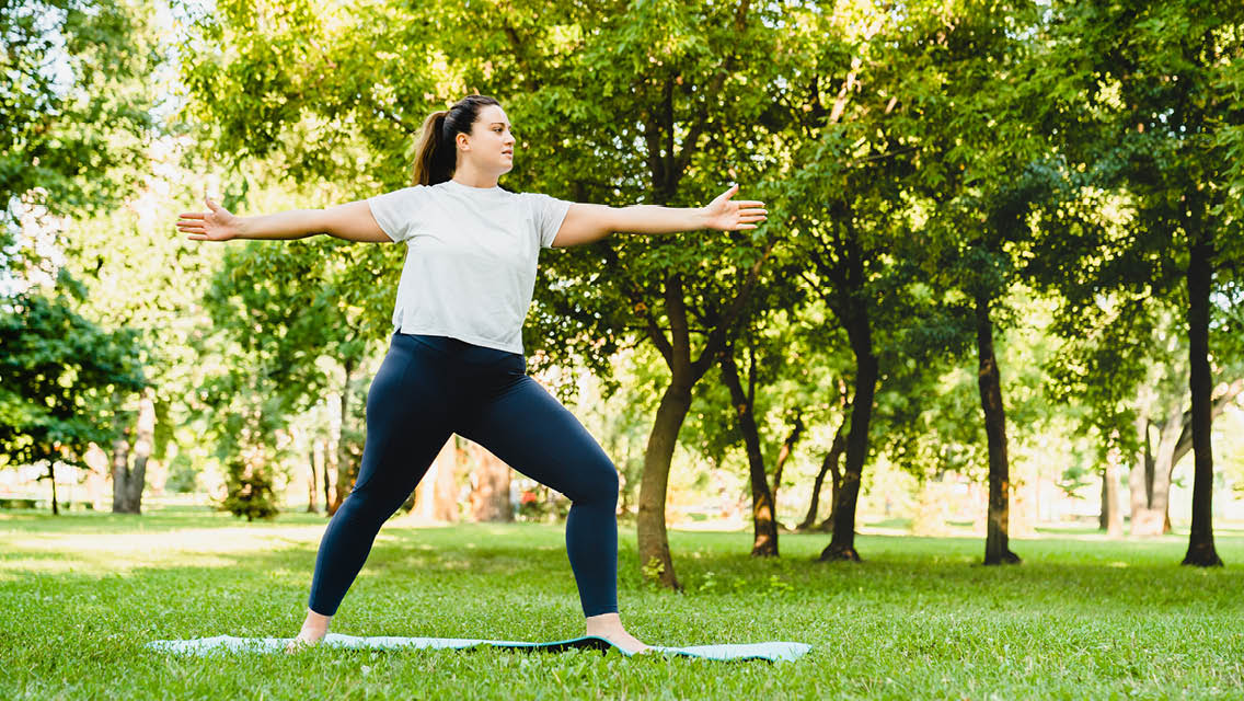 a woman holds a yoga pose