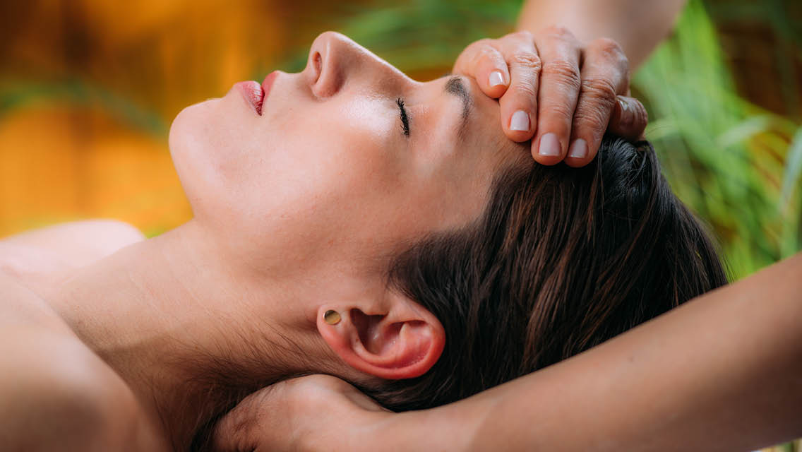 a woman receives a craniosacral treatment