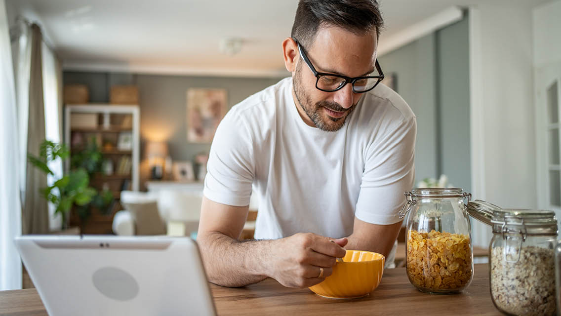a man eats cereal for breakfast.