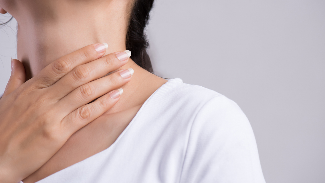 Hand touching thyroid gland