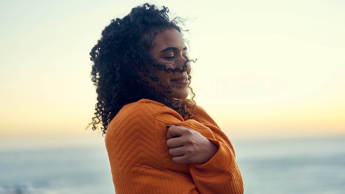 a woman hugs herself