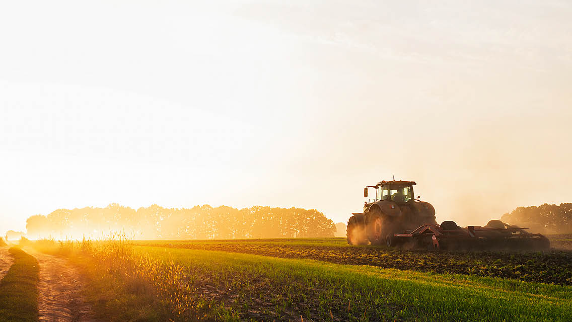 a tractor plowing a field