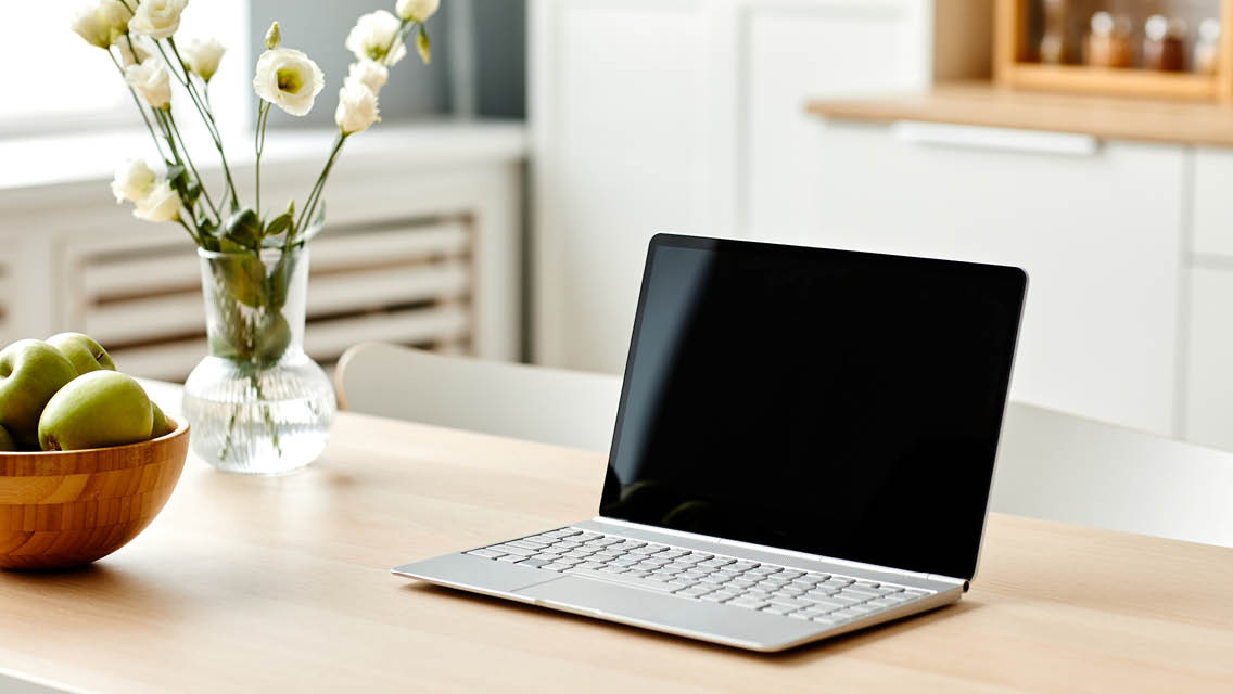 a laptop sits on a clear counter