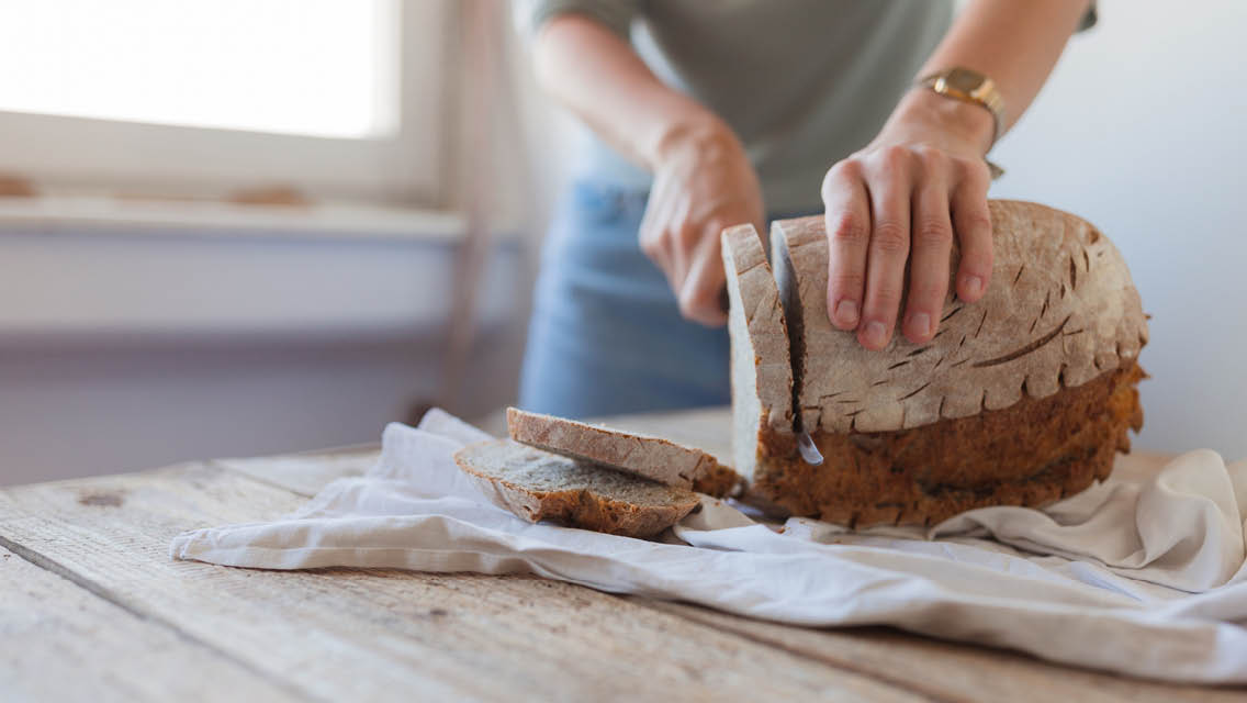 a woman slices bread