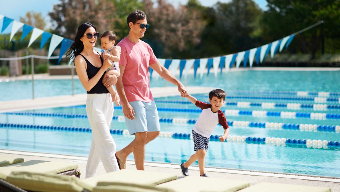 family walking by the pool