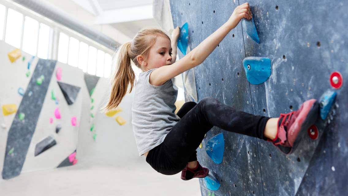 young girl rock climbing
