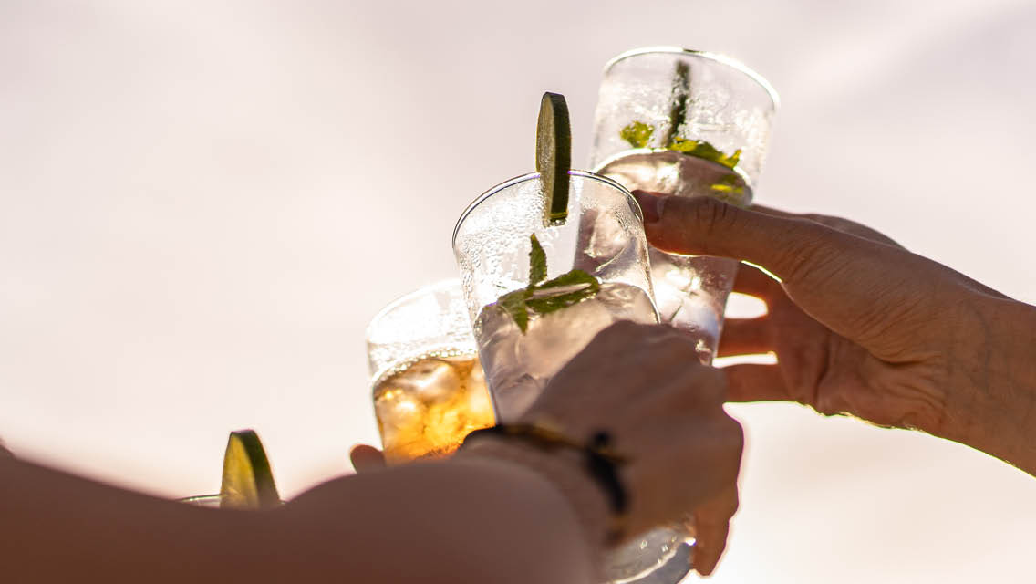 people clink glasses together