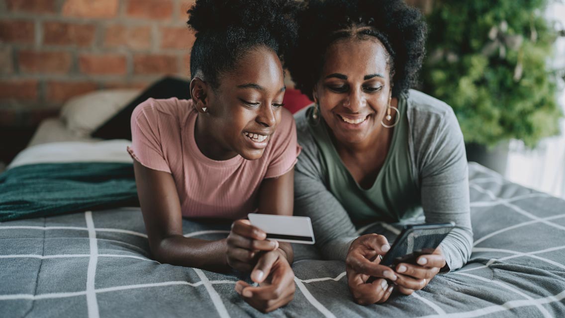 a mom and daughter look at finances