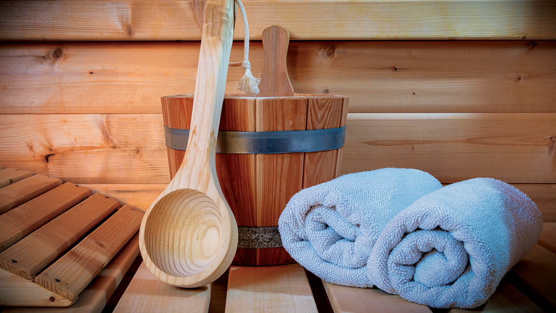 bucket spoon and towels in a suana