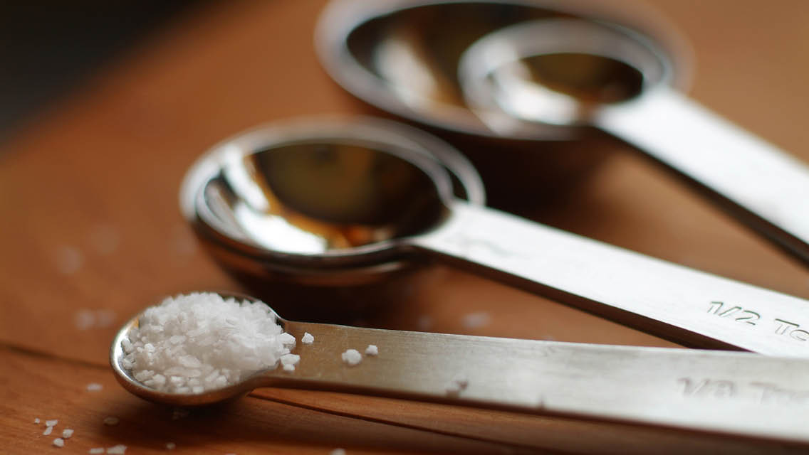 measuring spoons with one filled with salt