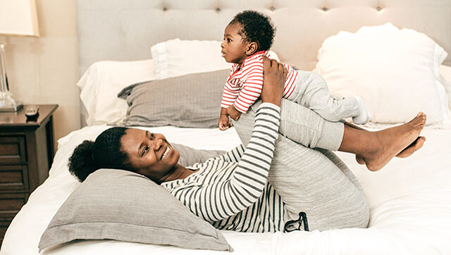 A mother plays with her baby.