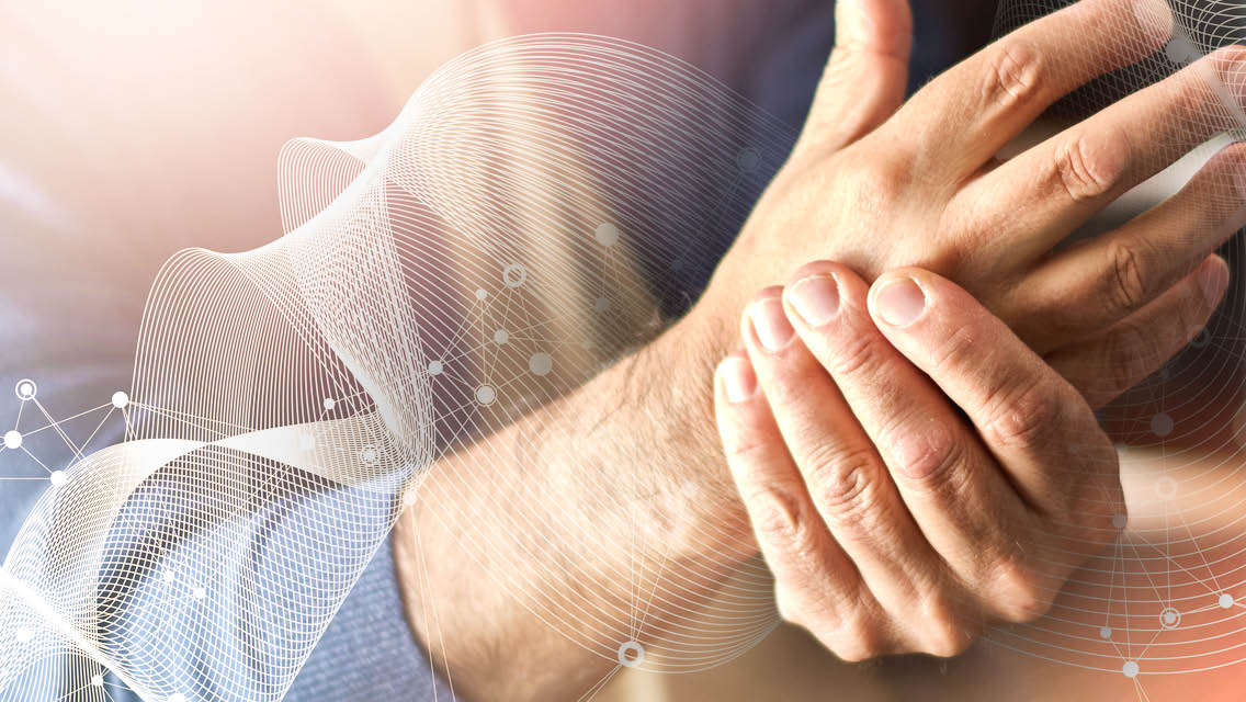 a man rubs his hand.